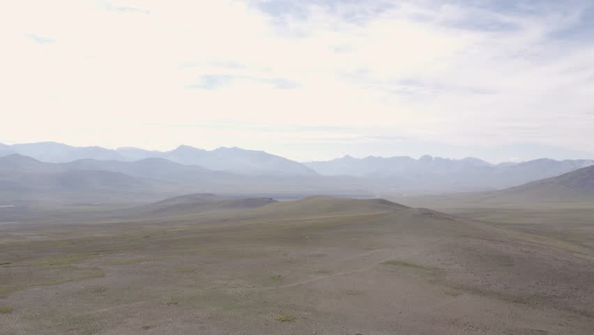 Expansive aerial view of Deosai’s high-altitude grasslands stretching toward distant mountain ranges. Gilgit-Baltistan, Pakistan
