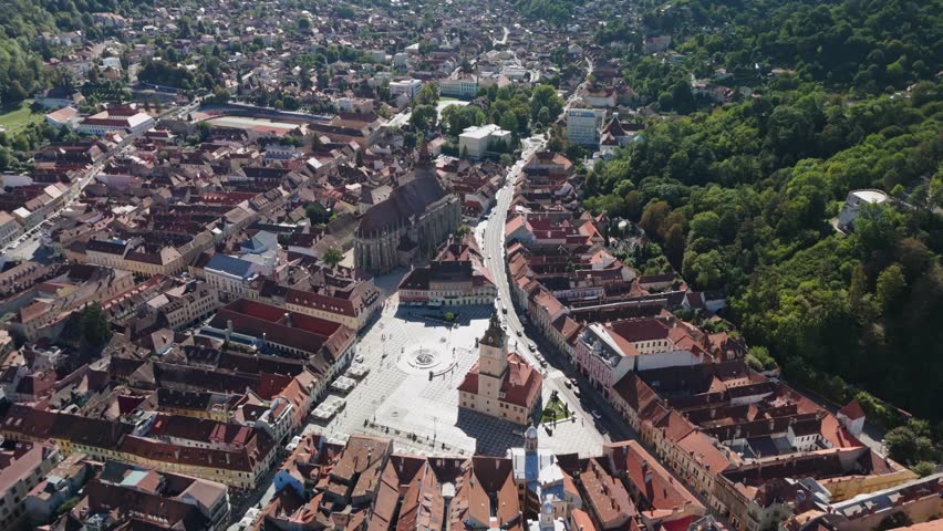 Aerial view of historic cityscape with red-roofed buildings and plaza
