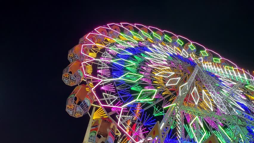 Video of Ferris Wheel or Joint wheel ride playing in night at fair ground during the annual fair.