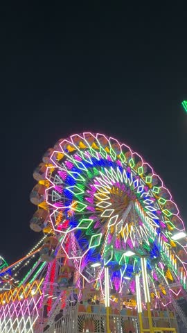 Video of Ferris Wheel or Joint wheel ride playing in night at fair ground during the annual fair.