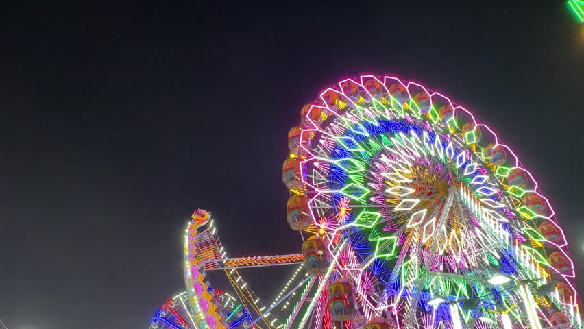 Video of Ferris Wheel or Joint wheel ride playing in night at fair ground during the annual fair.