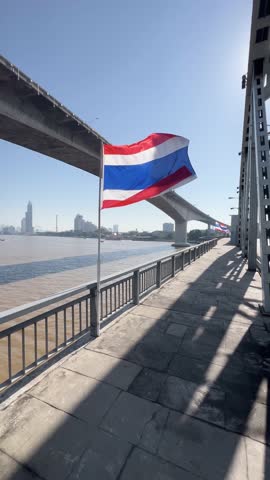 Thai flag on a bridge over the chao phraya river in Bangkok, Thailand