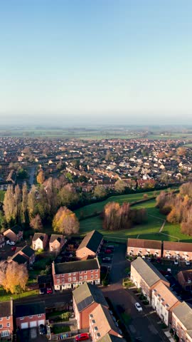 Portrait vertical aerial drone footage of the town of Batley in Wakefield in the UK, showing a typical British housing estate with rows of houses and homes in the West Yorkshire town in the winter