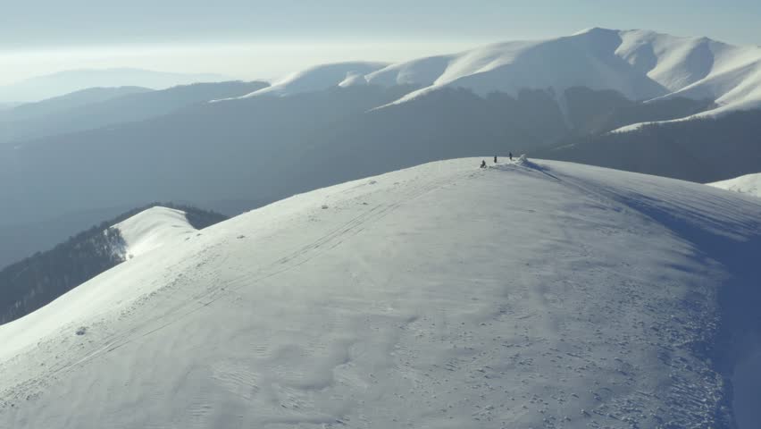 Aerial view of motorbikes on snowy mountains with dynamic riders