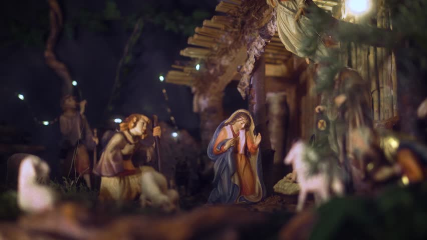 A Christmas manger scene with beautifully carved figures, including Jesus, Mary, Joseph, Archangel Gabriel, shepherds and animals. Emotions visible on the characters
