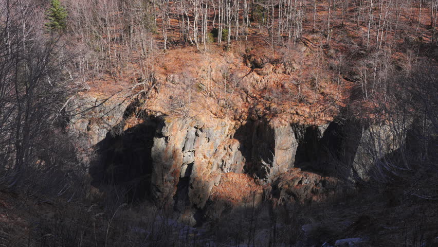 Mountain cliffs in the forest late autumn. 