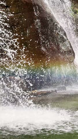 Melting glacier, waterfall from top of the mountains, view of the rainbow effect on the water flow at a rocky terrain, a foot of the Himalayan mountain range, UGC.