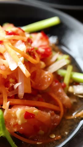 Slow camera pan across spicy salmon salad, fried rice, dipping sauces, and salmon sashimi