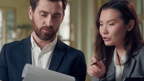 Multiethnic business team Korean businesswoman explaining idea gesturing convincing smiling Caucasian businessman listening agreement pen teamwork discussion success strategy office folder clipboard - Powered by Shutterstock - Get 15% off with code: PIKWIZARD15