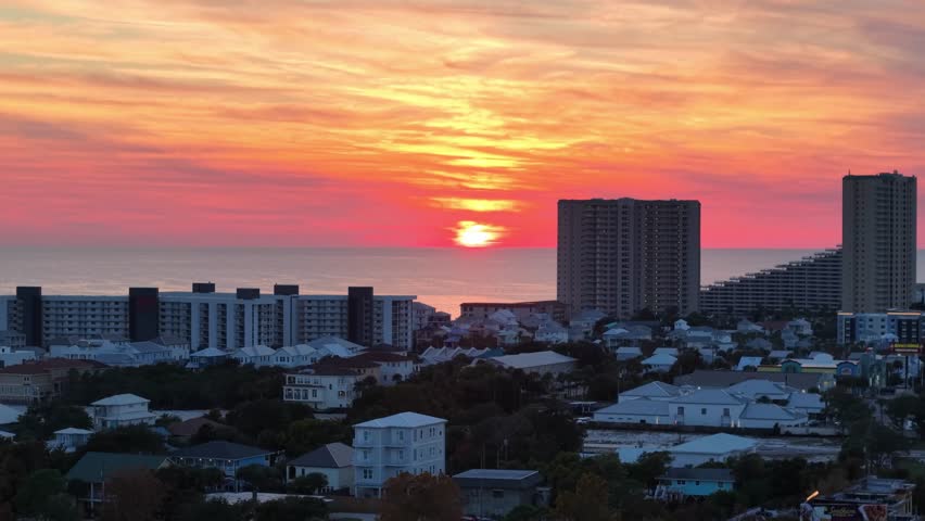 Sunset over beachfront Panama City Beach skyline with tall buildings in evening sky, Florida, USA