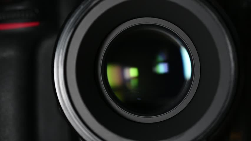 DSLR camera lens performing autofocus, creating a rapid, quiet motor whirring and slight clicking sound.