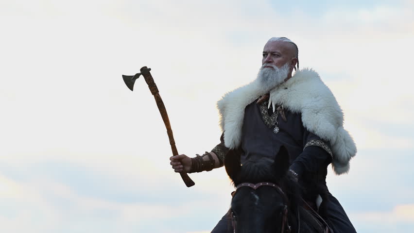 A Viking warrior draped in fur rides a powerful black horse across a vast landscape at sunset. The moment captures the raw spirit of ancient adventure and wilderness in a cinematic slow-motion style