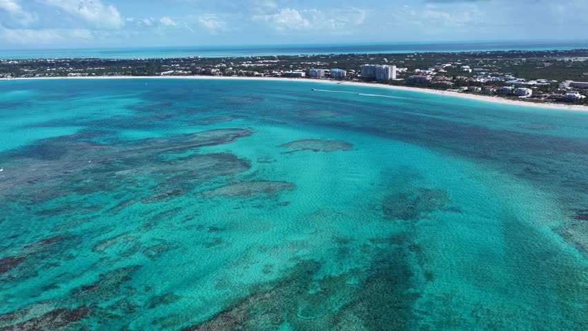 Grace Bay Beach At Providenciales In Overseas Territory Turks And Caicos Islands. Caribbean Beach. Tropical Scenery. Stunning Highrise Buildings. Grace Bay Beach In Turks And Caicos Islands.