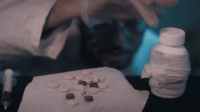 Cinematic Close-up of Various Pills on Table with Blurred Man Examining Drugs in Blue Light - Concept of Addiction and Substance Abuse 04.12.2025 morocco - Powered by Shutterstock - Get 15% off with code: PIKWIZARD15