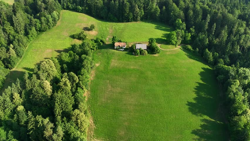 Drone view Drava riverside hills in summer, Gortina village, deep green forest on hills near river.