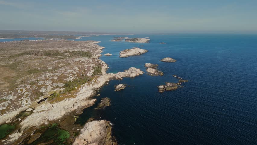 Aerial View Peggys Cove In Halifax, Nova Scotia, Featuring A Scenic Fishing Harbor With Lobster Boats, Charming Wooden Houses, Weathered Docks, And The Iconic Lighthouse Standing Rugged Granite Rocks
