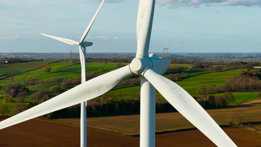 Blade wind turbine rotating. Wind turbine turning to convert wind into electricity. Windmill spinning to support clean power systems