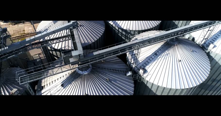 Drone view of large grain silos and an agricultural storage facility. Modern industrial infrastructure captured from above.
