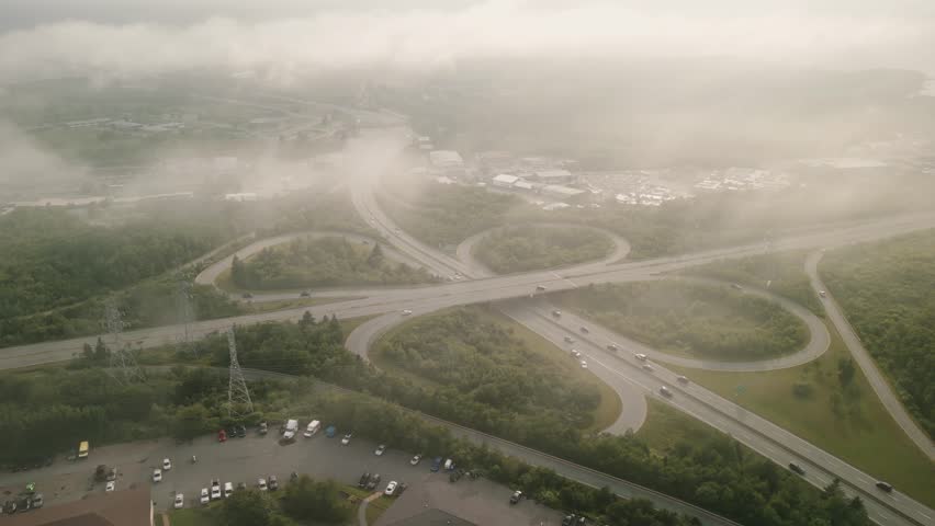 Aerial Scene Showing A Complex Highway Interchange In Dartmouth Nova Scotia Canada With Vehicles Moving Across The Bridge Toward Halifax Under Warm Sunlight Highlighting The Busy Coastal City Roads