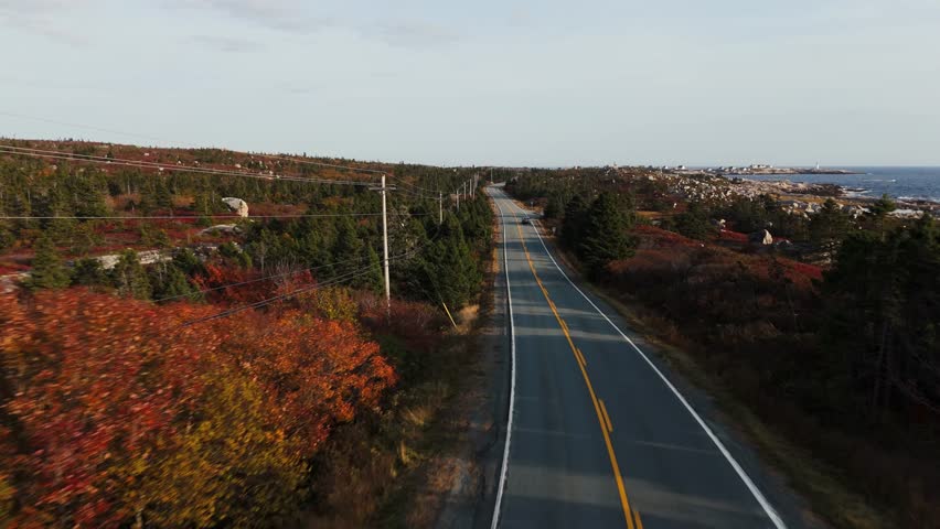 Aerial Scene Showing A Sports Car Driving Along A Coastal Road Near Peggys Cove In Halifax, Nova Scotia, With Blue Atlantic Waters, Summer Sunlight, And A Tourist Enjoying A Scenic Maritime Adventure