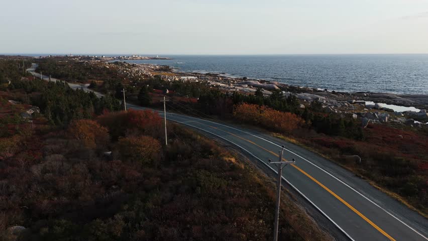 Aerial View Grey Car Following A Remote Coastal Road Near Peggys Cove In Halifax, Nova Scotia, With Stunning Atlantic Ocean Landscape Creating Summer Road Trip Feel Filled With Exploration And Freedom