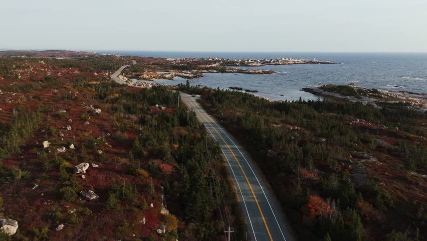 Aerial View Highlighting A Grey Car On An Empty Road Near Peggys Cove In Halifax, Nova Scotia, With Vast Atlantic Ocean Views And Warm Summer Atmosphere Enhancing A Peaceful Travel Journey