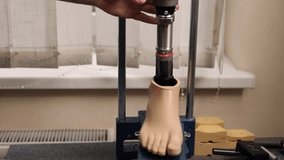 laser alignment, device engineer, stance analysis. Technician uses laser alignment system to precisely calibrate prosthetic foot on testing platform in clinical setting - Powered by Shutterstock - Get 15% off with code: PIKWIZARD15