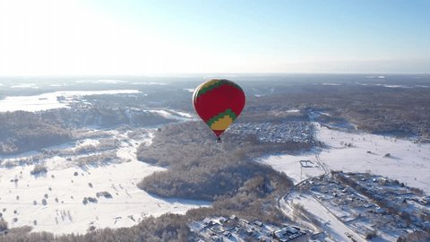 Drone Orbiting Hot Air Balloon over Snowy
