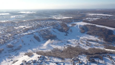 Drone Descending Forward over Winter Ski Terrain