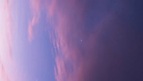 Vertical video - Timelapse of colorful dusk sky with waxing crescent moon visible - Powered by Shutterstock - Get 15% off with code: PIKWIZARD15