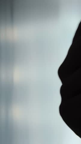 Man hand knocking on the door in a dark place. Home security and protection concept. vertical