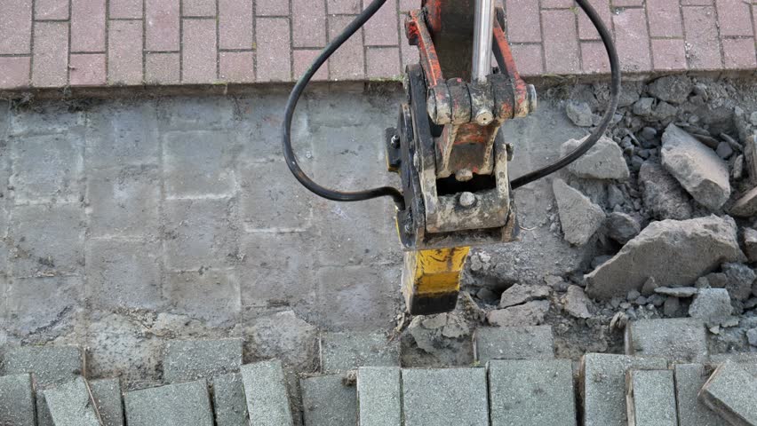 Jackhammer working on brick paver patio removal early morning project destroying hardscape destroying gray stone blocks