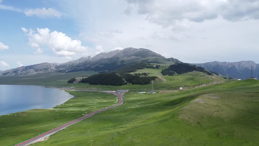 explore the breathtaking scenery of the lake and mountains. enjoy the green hills and scenic views. a perfect travel destination for nature lovers. beautiful landscape!