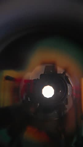 lens image with vibrant shapes, silhouette captured through glass with bold aperture, handheld photo featuring silhouette in lens glass with energetic color contrasts and geometric aperture