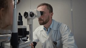 Zoom out shot of smiling male doctor giving lollipop to child after eye exam with slit lamp in ophthalmology clinic, copy space - Powered by Shutterstock - Get 15% off with code: PIKWIZARD15