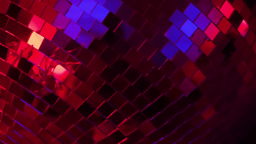 This captivating footage of a disco ball illuminated with colorful lights enhances the dance floor vibes