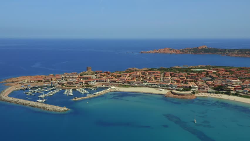 Aerial drone view of Castelsardo and Isola Rossa seaside town with a marina along the azure coastline of Sardinia, Italy