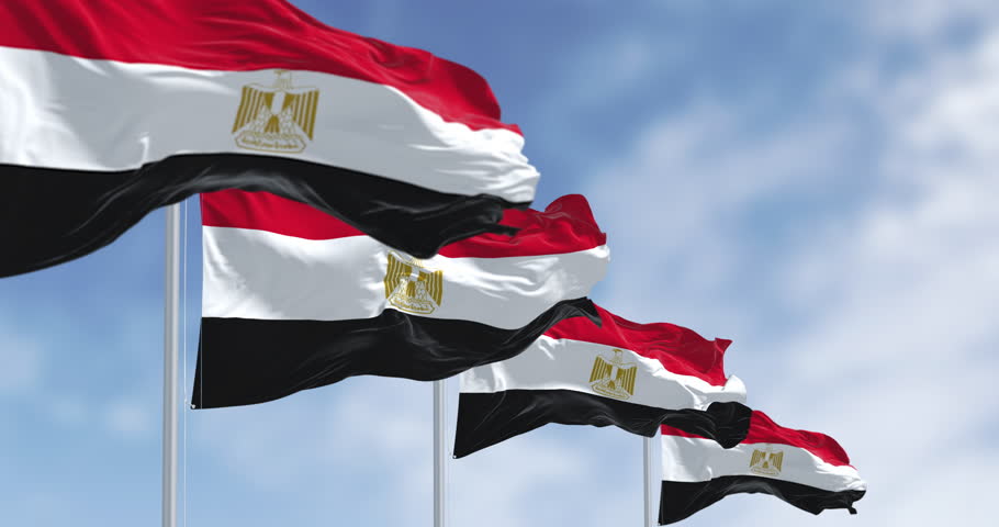 National flags of Egypt waving on a clear day. Horizontal red, white and black bands. Egyptian eagle emblem centered in white band. Seamless 3d render animation. Slow motion loop. Selective focus
