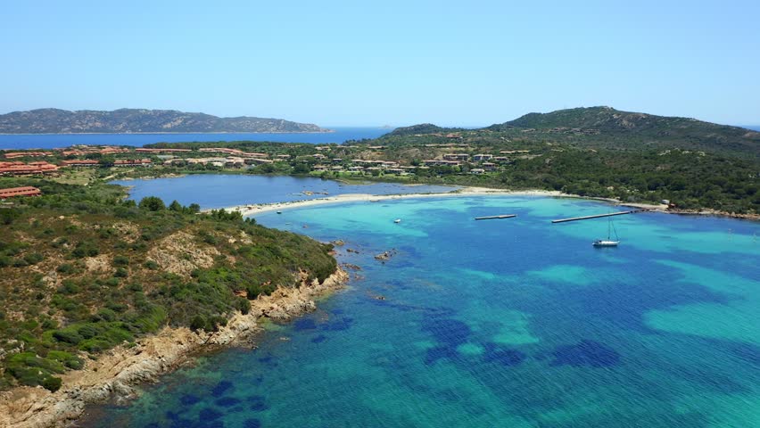 Drone aerial view of Salina Bamba beach with Isola Molara islet on the background in Sardinia, Italy