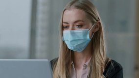 Caucasian business woman in face medical mask showing thumb up satisfied businesswoman female girl recommend safety rules coronavirus protection with laptop computer in office health care like gesture - Powered by Shutterstock - Get 15% off with code: PIKWIZARD15