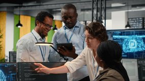 Multiethnic technicians use devices in AI startup office to train predictive models for language processing tasks. Multiracial coworkers use deep learning technical expertise for tasks, camera B - Powered by Shutterstock - Get 15% off with code: PIKWIZARD15