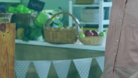 Market stall vendor holding tomatoes and tapping phone, generating marketing bubbles boosting sales. Produce, baskets, wooden, counter, smartphone, notifications, retail - Powered by Shutterstock - Get 15% off with code: PIKWIZARD15