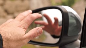 Man's Hand Waving or Pointing in Car Side Mirror Reflection, Dynamic Action - Powered by Shutterstock - Get 15% off with code: PIKWIZARD15