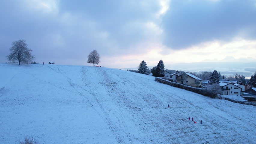 Aerial of a snowy landscape, revealing the city and lake of Uster, Switzerland