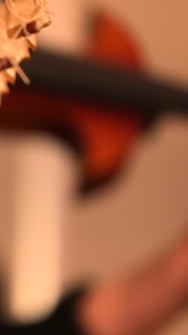 Closeup of fingers on acoustic guitar strings and neck live concert music