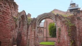 A young woman carefully walks down the weathered stone steps of a ruined ancient church in Chester, England. A scene of historical exploration, travel, and discovering UK heritage sites - Powered by Shutterstock - Get 15% off with code: PIKWIZARD15