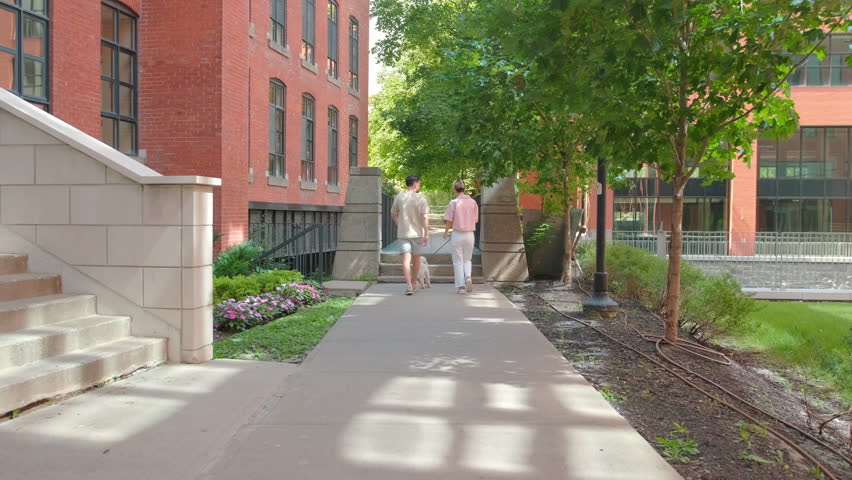 Couple walking between brick buildings in Montreal
