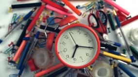 An alarm clock with various school supplies flies up and falls. Filmed on a high-speed camera at 1000 fps. High quality FullHD footage - Powered by Shutterstock - Get 15% off with code: PIKWIZARD15