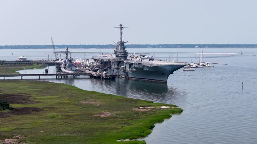 Aerial drone footage approaching the USS Yorktown aircraft carrier at its dock in Charleston