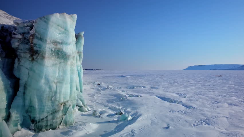 East coast of main island of Svalbard - Spitsbergen and specifically Mohnbukta bay with it's massive glacier front over sea ice.